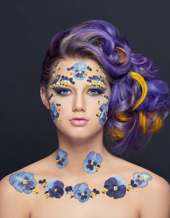 Creative Makeup by Saskatoon Makeup Artist Jennilee Cardinal Schultz. Photo by Bill Hamilton. Woman with floral face and body paint against a dark background