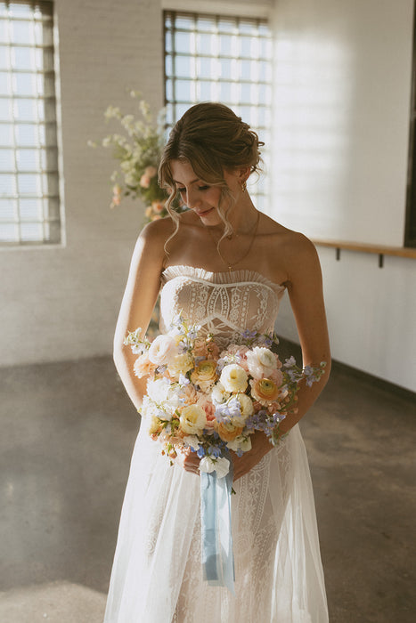 Makeup work by Saskatoon Makeup Artist Jennilee Cardinal Schultz for Bridal Parties and Weddings. Photos by Chelsea Pratchler. Saskatoon Bride in a white lace wedding dress holding a bouquet of flowers in an indoor setting.