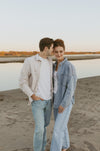 Makeup work by Saskatoon Makeup Artist Jennilee Cardinal Schultz for Engagement photos. Photos by Chelsea Pratchler.
Two people standing close together on a beach at sunset.