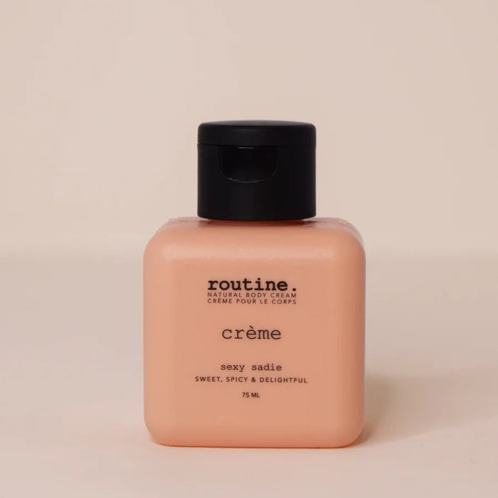Body cream bottle labeled 'routine' on a beige background