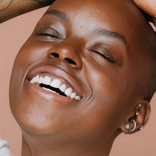 Model wearing Elate Cosmetics Better Balm  Made in Canada, cruelty-free, plastic-free
