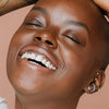 Model wearing Elate Cosmetics Better Balm  Made in Canada, cruelty-free, plastic-free