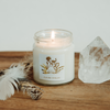 lit luxury air element crystal infused soy intention candle on wooden tray