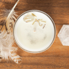 top view of air element crystal infused soy intention candle on wooden tray