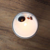 top view of lit luxury capricorn zodiac crystal infused intention candle