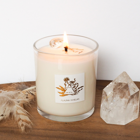 lit luxury air element crystal infused soy intention candle on wooden tray