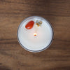 top view of lit luxury aries zodiac crystal infused intention candle