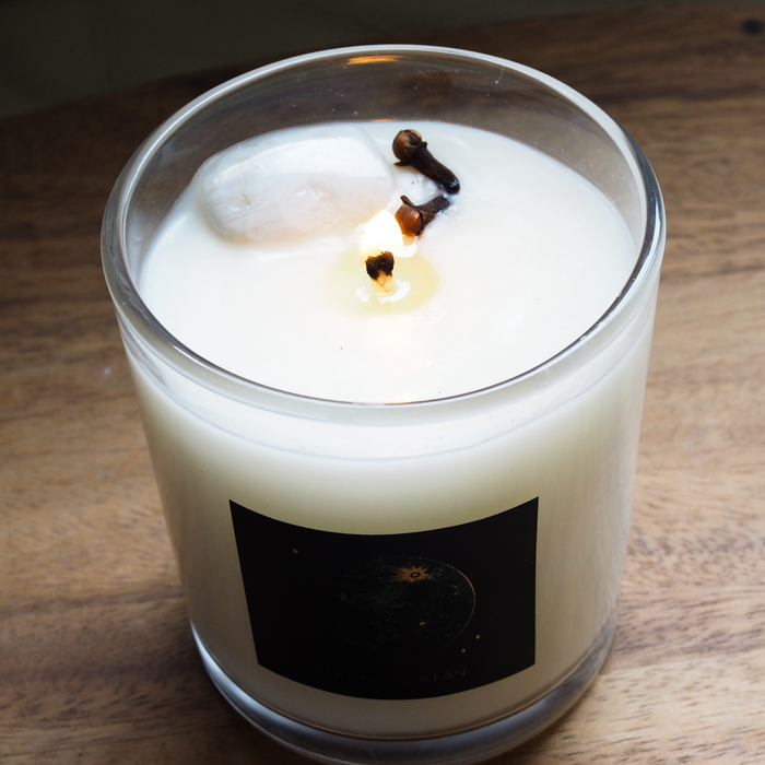 top view of lit luxury waxing moon crystal infused soy intention candle